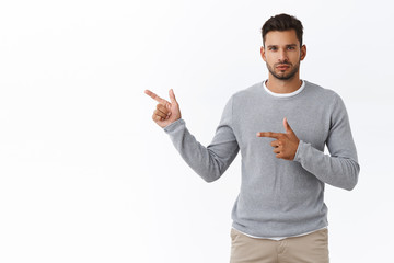Serious-looking confident and sassy masculine macho man with bristle in modern grey sweater over...