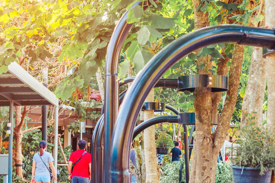 Black steel column supports and controls the branches and trunks of the tree to stand upright and beautiful in the park.