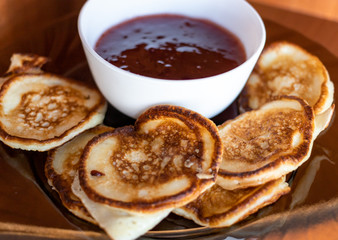 freshly made pancakes are on the plate with jam
