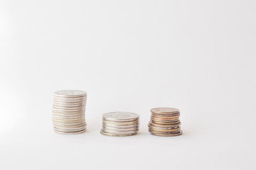  Three piles of coins on a white background. concept of money, finance, business. Berabota increase. copy space for text
