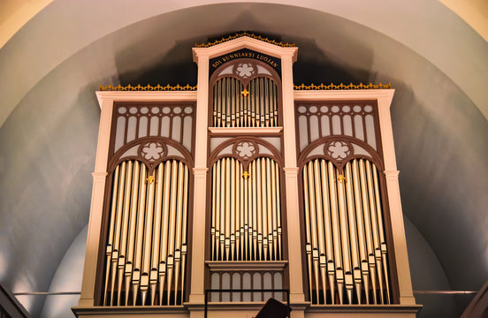 Old Christian church organ instrument under the arch. Christian historic architecture scene in Finland