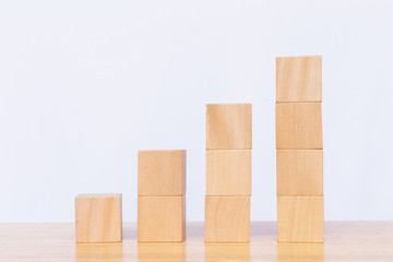 Wooden cube stack a staircase on white background. Concept of success, winner, victory or top ranking