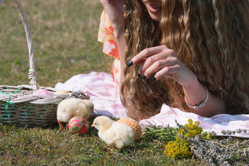 Girl and two little yellow chikens.