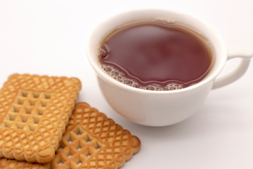 White mug with tea and cookies on a white background