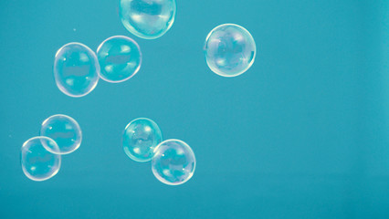 Shampoo bubbles floating like flying in the air by wind blow which represent refreshing playful or joyful moments and gentle soft comfortable and look wet and soapy for hygiene detergent product indus