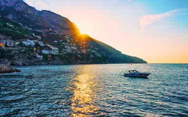 Sunset and Yacht at Amalfi town in Tyrrhenian sea reflex