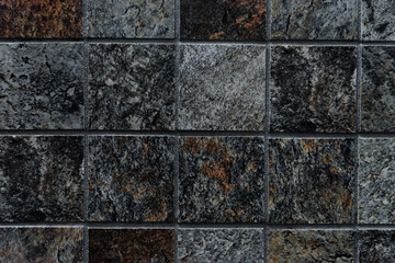 The colorful vintage ceramic tiles wall decoration,tile mosaic in the bathroom,vintage mosaic tiles texture background,gray and black mosaic wall texture and background