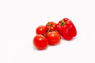 Red tomatoes and pepper on a white background