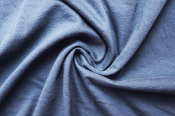 Fototapeta na wymiar Wavy blue cloth texture, worn messy fabric pattern background. Drapery sheet messy light azure blue colour, soft linen detailed sheets close up top view