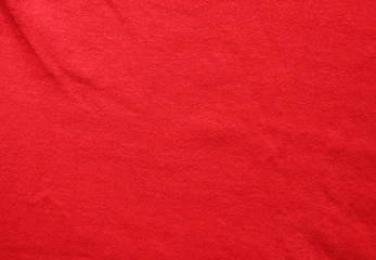 Red fabric texture background with wrinkles. Worn red clothing structure, creased pattern element,...