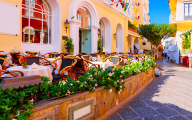 Fototapeta na wymiar Street cafe and restaurant table with chair Capri Island Italy reflex
