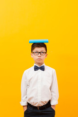 Copy-space boy with book on head