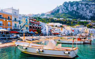 Fototapeta na wymiar Marina with yachts at Capri Island town at Naples Italy reflex