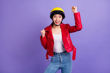 Portrait of astonished cheerful girl impressed lucky motor sport race competition win raise fists scream yeah wear denim isolated over purple color background