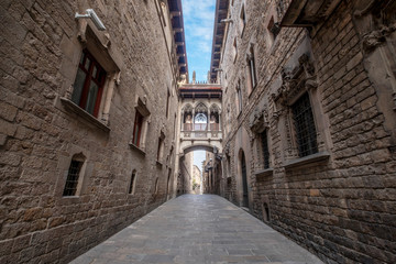 Fototapeta na wymiar Barcelona, Catalonia / Spain: 04 09 2020: empty streets in the Bisbe street, in the Gothic Quarter in the city of Barcelona during the covid-19 coronavirus pandemic