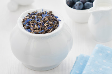 Fototapeta na wymiar Chinese tea with blueberry slices on a white background