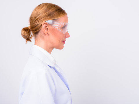 Profile view of blonde woman doctor as scientist
