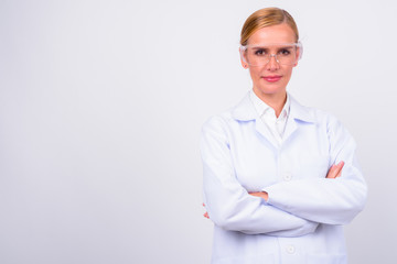 Portrait of blonde woman doctor as scientist with arms crossed