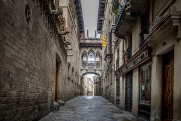 Fototapeta na wymiar Barcelona, Catalonia / Spain: 04 09 2020: empty streets in the Bisbe street, in the Gothic Quarter in the city of Barcelona during the covid-19 coronavirus pandemic