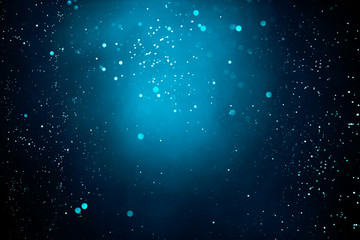 Obraz premium Abstract dark background with glowing turquoise particles.