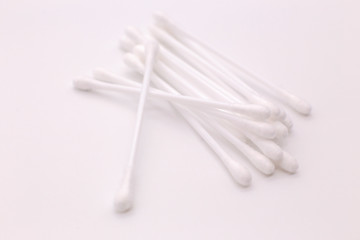 Lots of cotton swabs on a white background