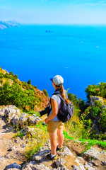 Woman photographer at Path of Gods in Tyrrhenian sea reflex