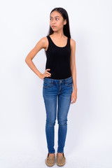 Full body shot of young Asian woman looking away