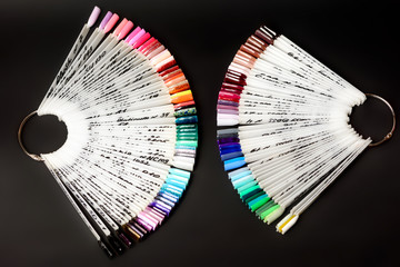 A palette of nails polish for professional manicures on a dark background