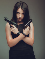 Fototapeta premium Shot of a sexy military woman posing with guns