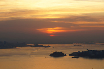Sunset at Niteroi and Rio de Janeiro cities, Brazil. View of tourist spots in the cities, such as Guanabara Bay, Sugarloaf Cable Car, Christ the Redeemer statue