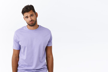 Obraz premium Cute and silly charming boyfriend looking gloomy at girlfriend complaining tough day, sulking and gazing with condole or compassion, feeling empathy person having bad day, standing white background