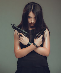 Fototapeta premium Shot of a sexy military woman posing with guns