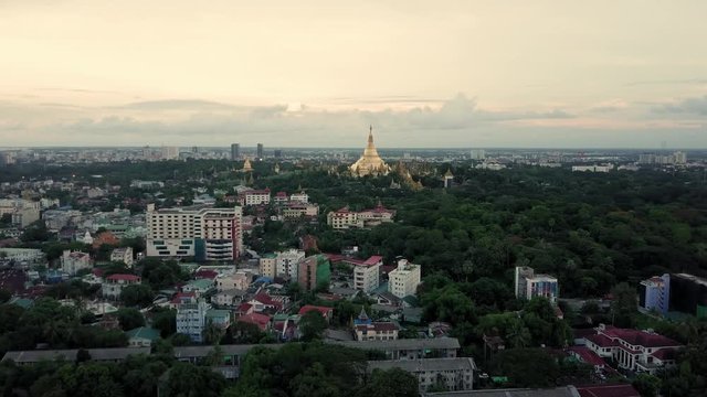 Yangon (Shwedagon pagoda) at sunset by drone in 4K. Over the city forward movement.