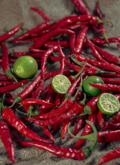 Red hot chilli peppers with lime on burlap sack