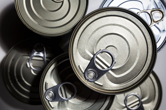 Overhead view of unopened cans of conserved food.