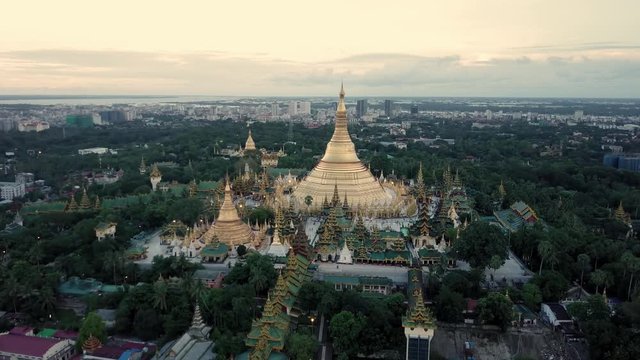 Yangon (Shwedagon pagoda) at sunset by drone in 4K. Close forward movement.