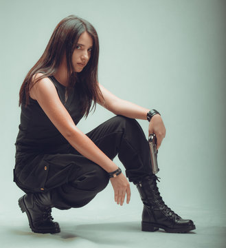 Shot of a sexy military woman posing with guns