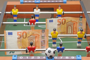 Fototapeta premium Table soccer football game - sports betting in the world of football - pleyers and euro mo