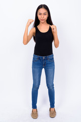Full body shot of young Asian woman ready to fight