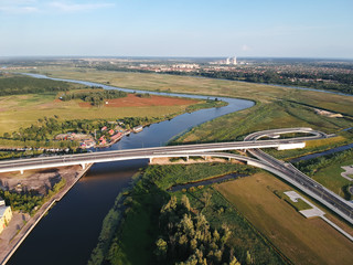 Fototapeta premium Drone photo, bridge over the river, in the sunset light. Panorama of the city of Kaliningrad, Russia. 