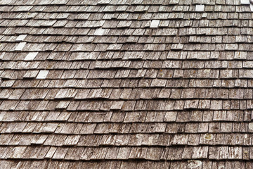 background, the roof of the old house of the house is covered with wooden tiles