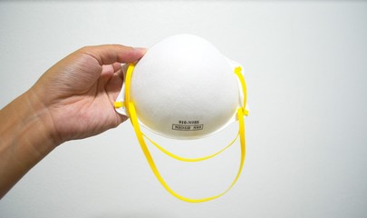 Hand holding KN95 or N95 mask for protection pm 2.5/pm2.5 and corona virus (COVIT-19).Anti pollution mask.air face mask.
