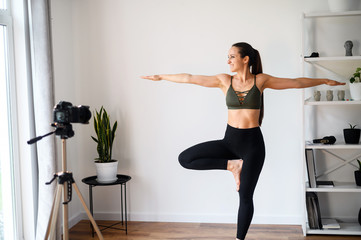 Fototapeta na wymiar Female yoga coach records video tutorial