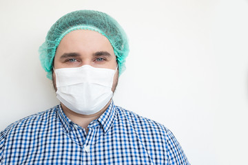 COVID-19 Coronavirus pandemic happy doctor positive with hope wearing surgical mask at hospital. Inspiring confidence in the future to solve the crisis.