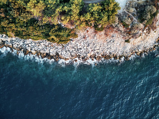 Top drone shot of blue ocean water in turkey. aerial evening mood of the coast beach. waves of turkise white water.