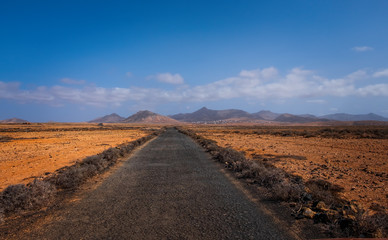 Fototapeta na wymiar The beautiful volcanic landscape with the road in Bailadero De Las Brujas on the island of Fuerteventura. Canary Islands. Spain. October 2019