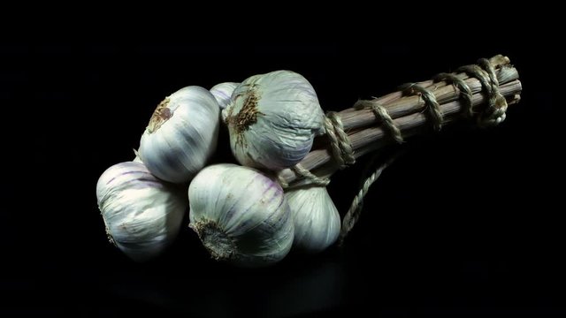 Bunch of garlic tied together , close up shot. Macro slider shot.