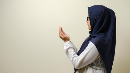 Asian Muslim women wearing hijab praying