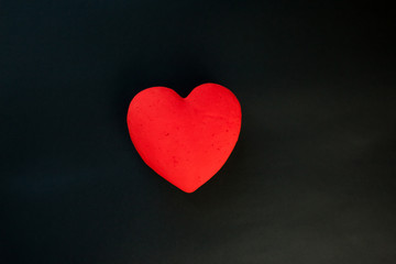Red heart, on the black velvet background