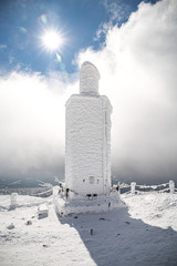 A frosty mound on a summit of Snezka mountain,trigonometric point located on borders with Poland. Winter picture of Czech national park called Krkonose.